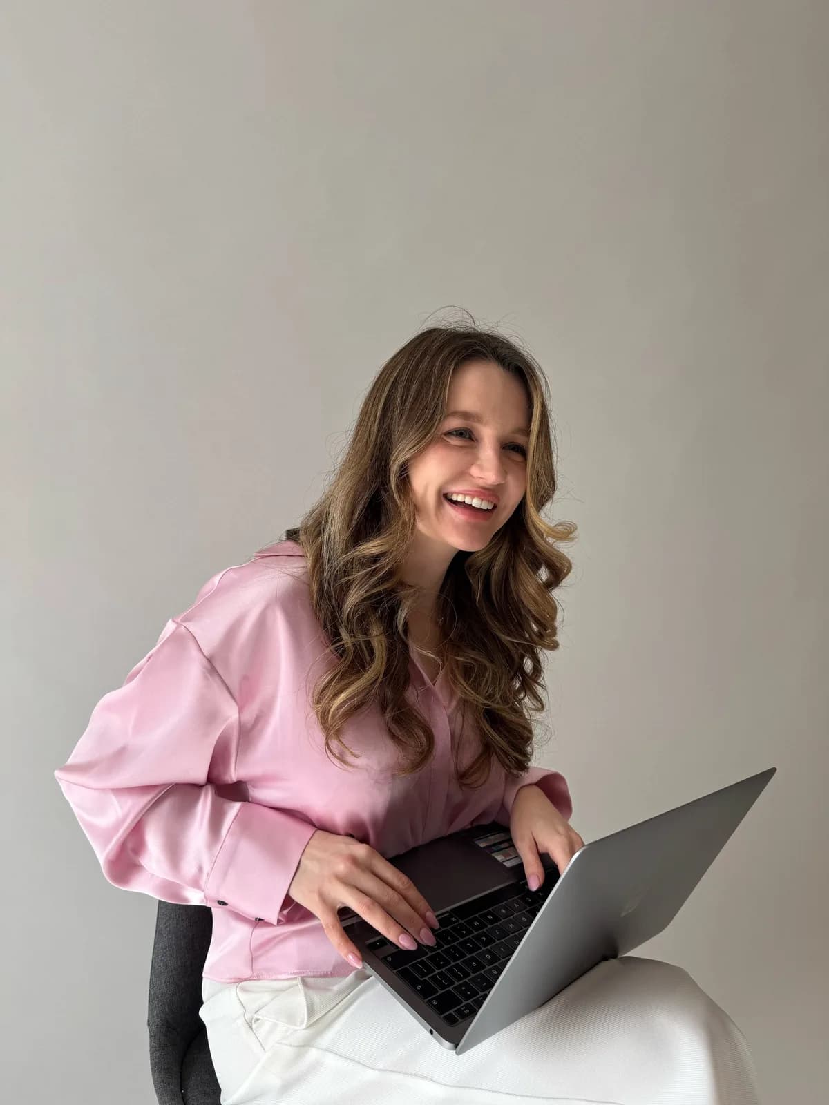 Yulia, bilingual education consultant, laughing with her laptop